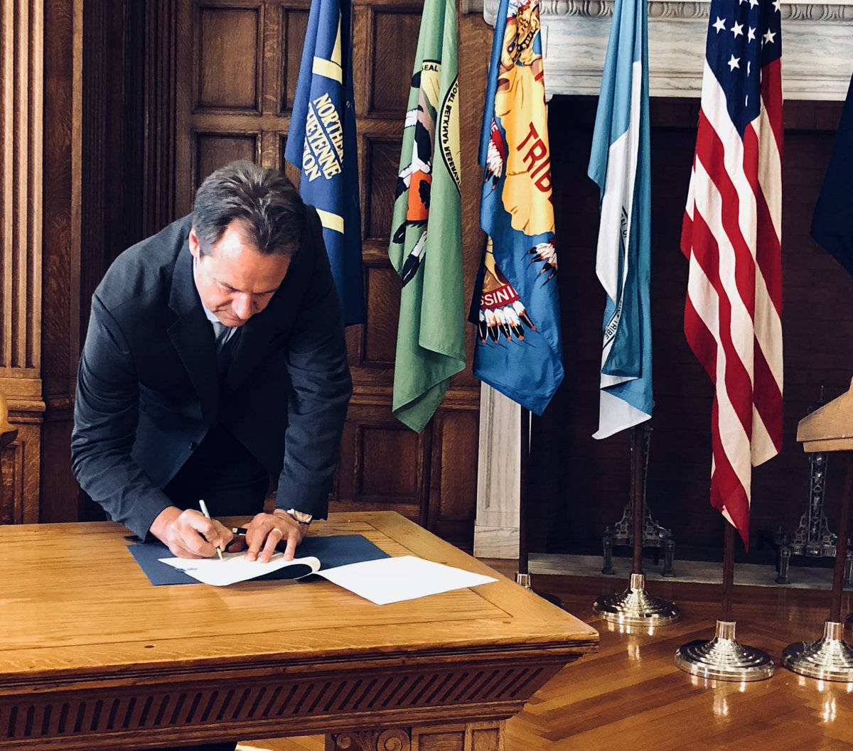 Photo of Governor Bullock signing executive order